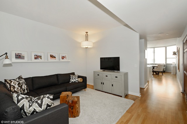 720 West Randolph Street, Unit 808 Chicago, IL 60661 - Photo 6 of 15 a living room with furniture and a flat screen tv