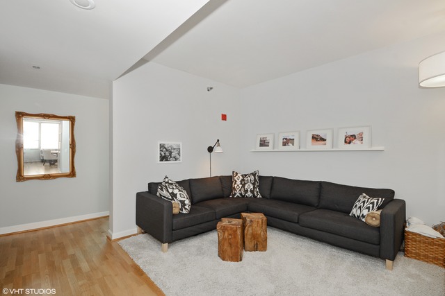 720 West Randolph Street, Unit 808 Chicago, IL 60661 - Photo 7 of 15 a living room with furniture and a wooden floor
