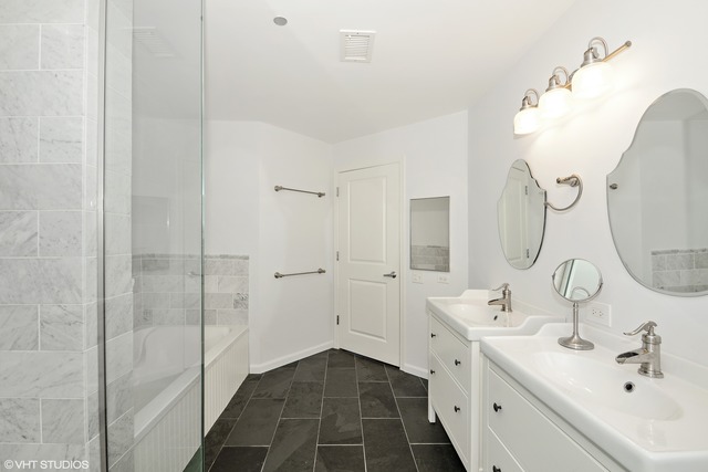 720 West Randolph Street, Unit 808 Chicago, IL 60661 - Photo 10 of 15 a bathroom with a double vanity sink mirror and shower