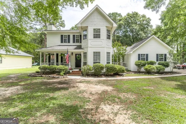 a front view of a house with a yard and porch