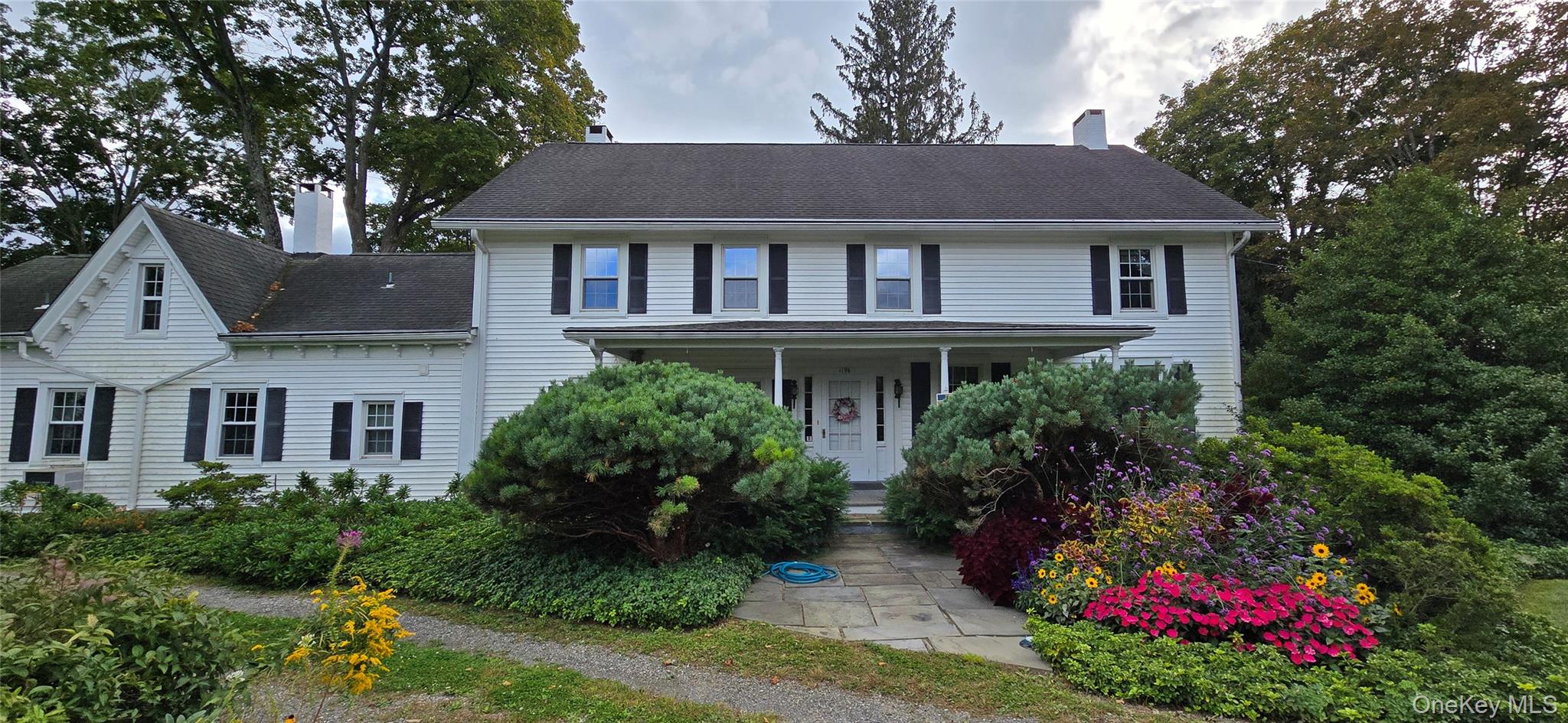 1196 82nd Route Hopewell Junction, NY 12533 - Photo 1 of 17 a front view of a house with a yard and garden