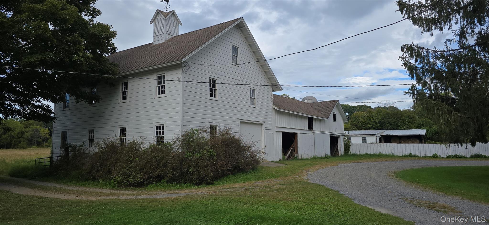 1196 82nd Route Hopewell Junction, NY 12533 - Photo 10 of 17 a view of a white house next to a yard and large trees