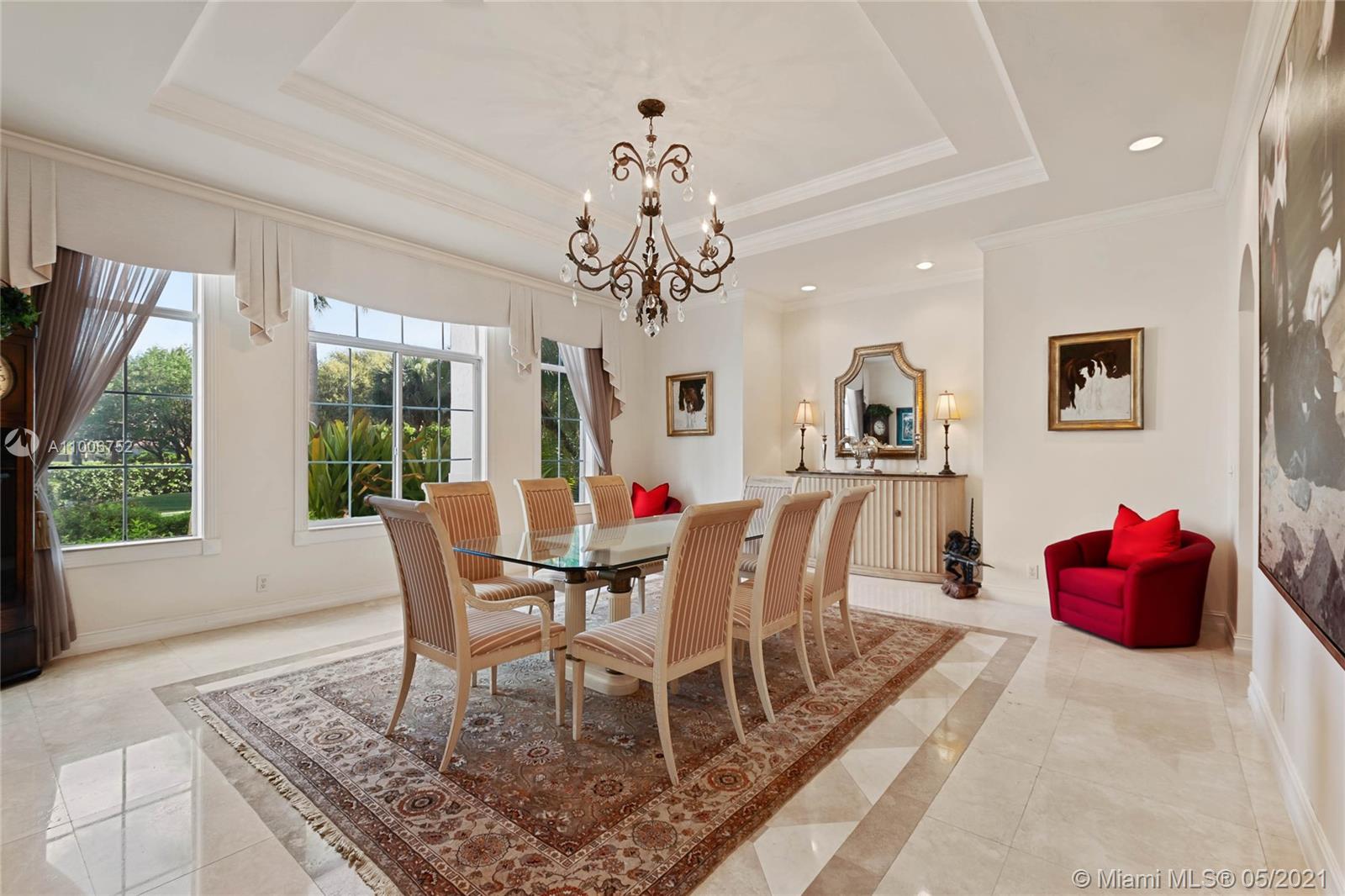 2920 Luckie Road Weston, FL 33331 - Photo 15 of 60 a dining room with wooden floor a chandelier a wooden table and chairs