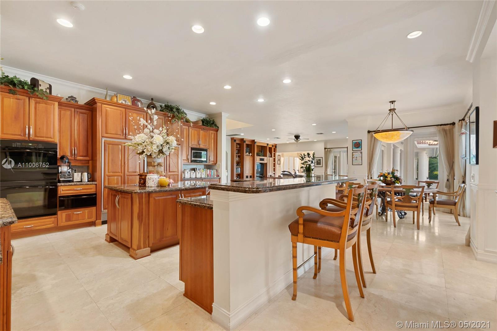 2920 Luckie Road Weston, FL 33331 - Photo 16 of 60 a open kitchen with stainless steel appliances kitchen island granite countertop a refrigerator and a sink
