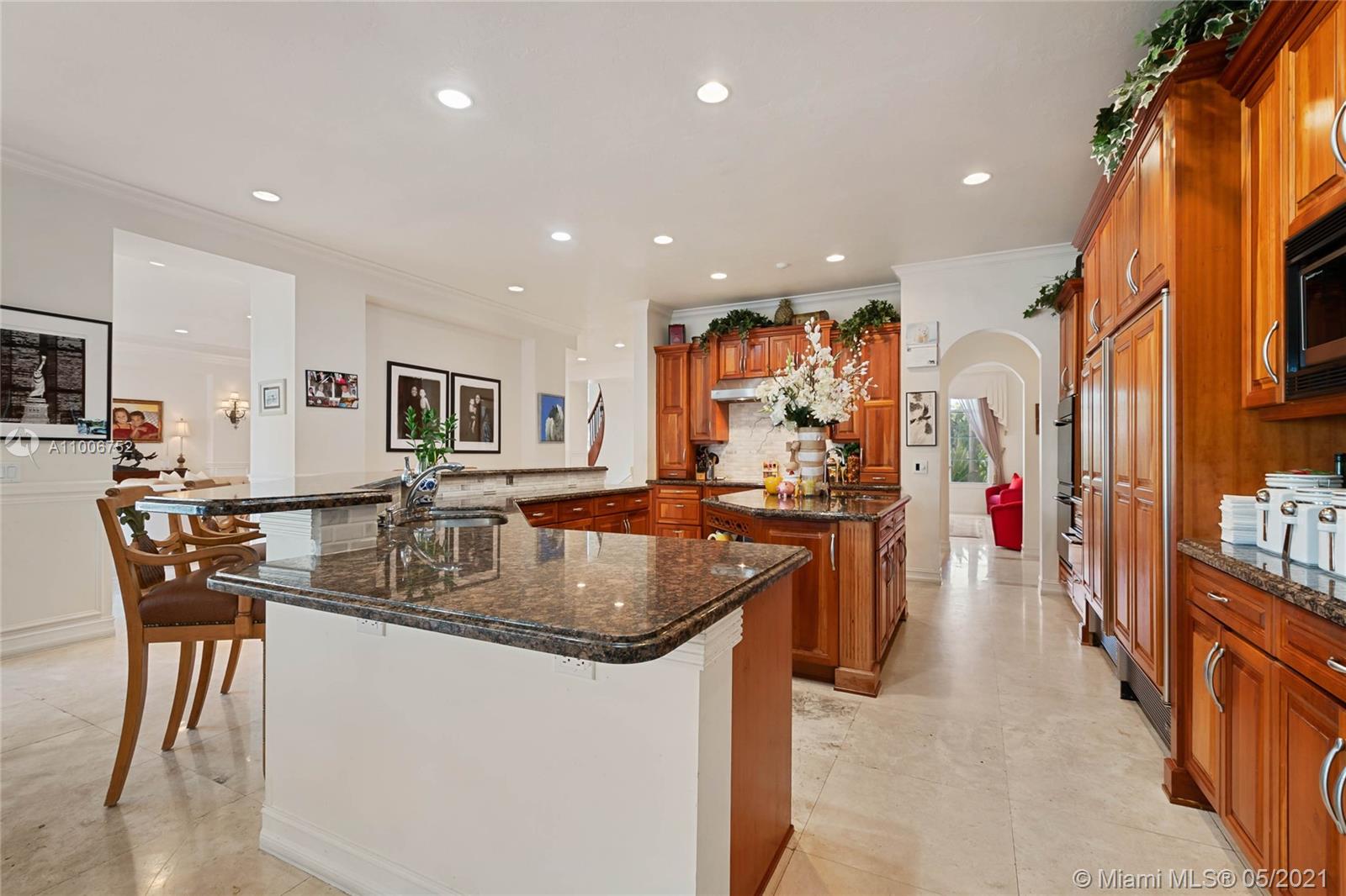 2920 Luckie Road Weston, FL 33331 - Photo 18 of 60 a kitchen with stainless steel appliances granite countertop a sink and a refrigerator