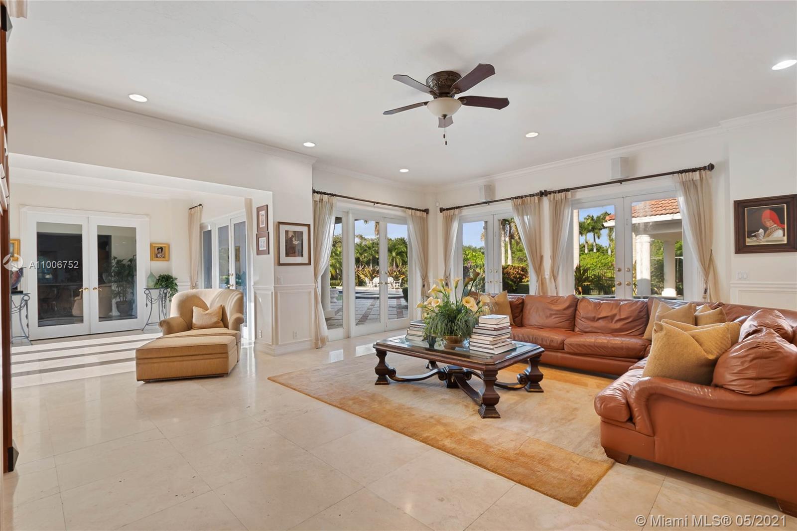 2920 Luckie Road Weston, FL 33331 - Photo 4 of 60 a living room with furniture and floor to ceiling windows