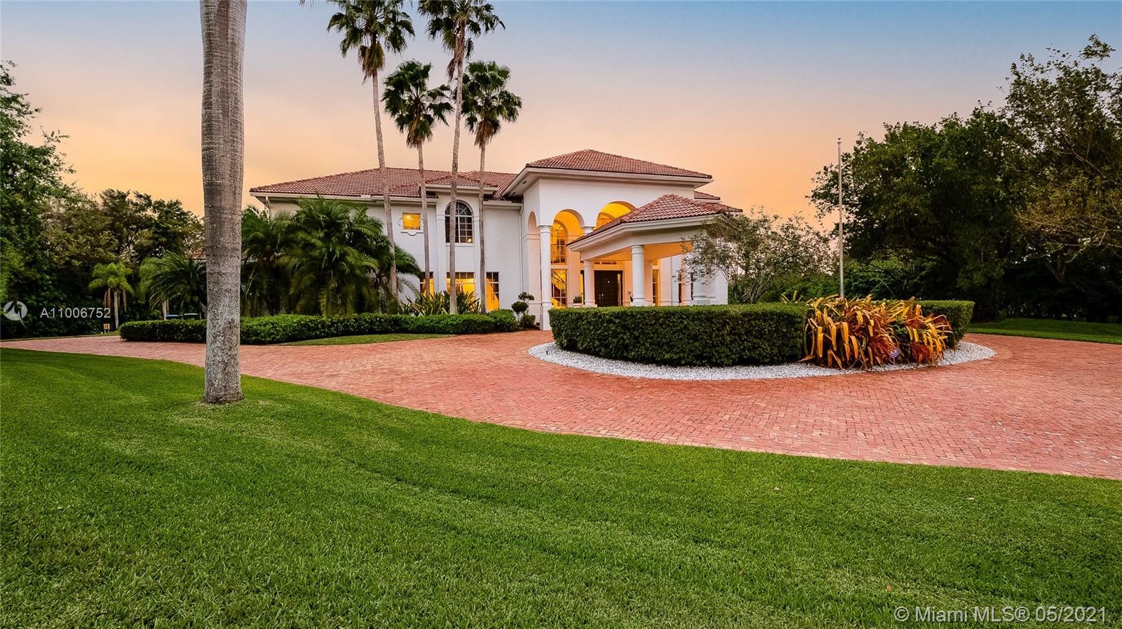 2920 Luckie Road Weston, FL 33331 - Photo 39 of 60 a front view of a house with a yard and potted plants