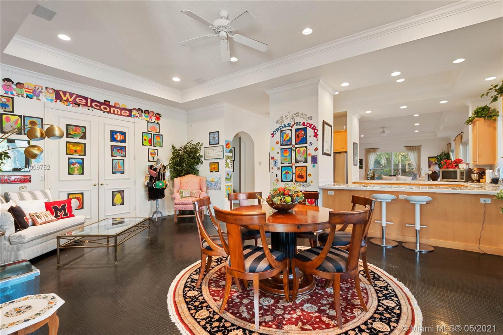 2920 Luckie Road Weston, FL 33331 - Photo 43 of 60 a dining room with lots of furniture a rug and a chandelier