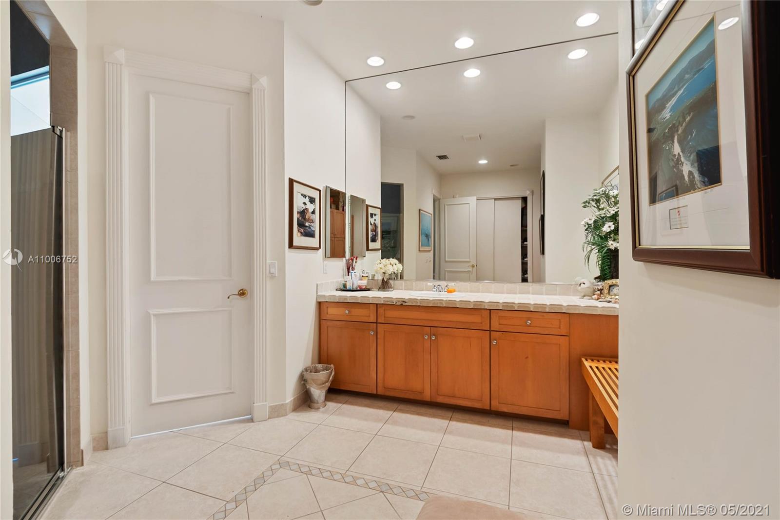 2920 Luckie Road Weston, FL 33331 - Photo 46 of 60 a large bathroom with a large mirror vanity and shower