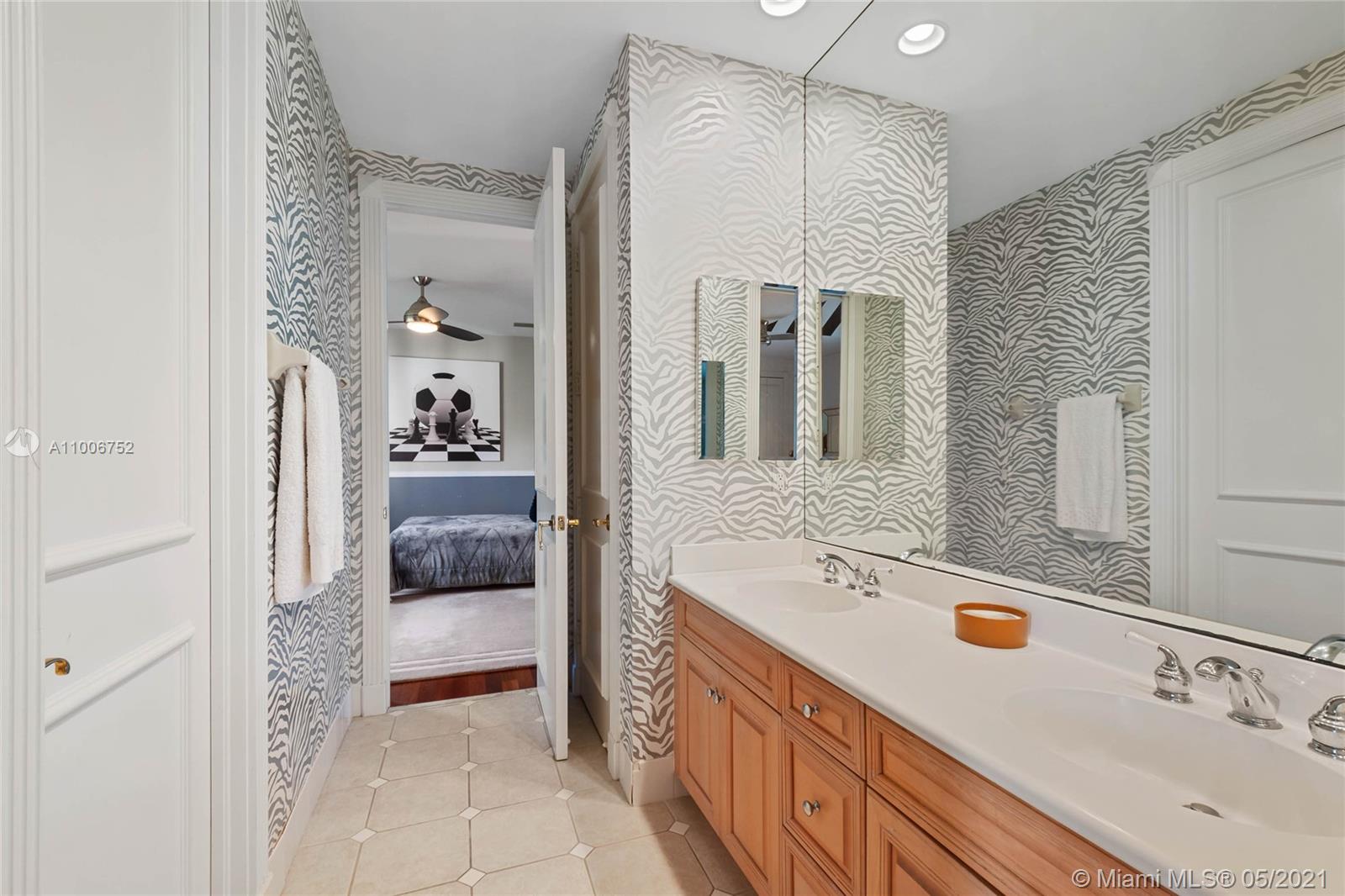 2920 Luckie Road Weston, FL 33331 - Photo 50 of 60 a en suite bathroom with a sink and a mirror