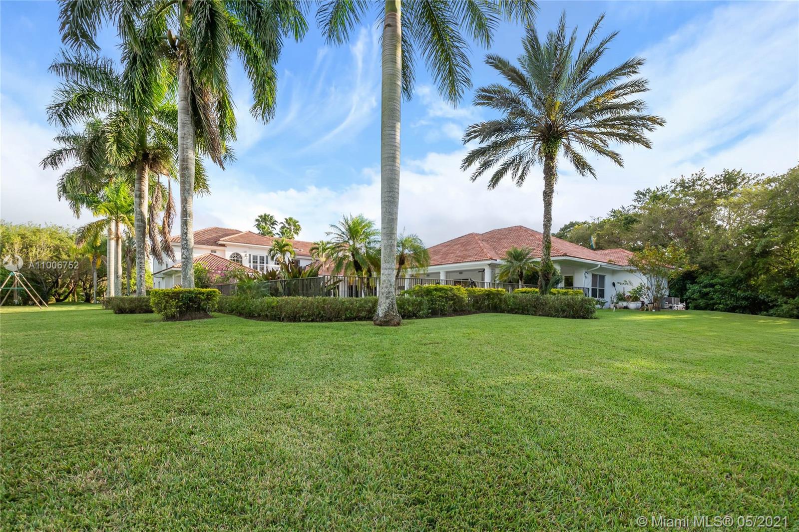 2920 Luckie Road Weston, FL 33331 - Photo 59 of 60 a view of a palm trees in front of a house