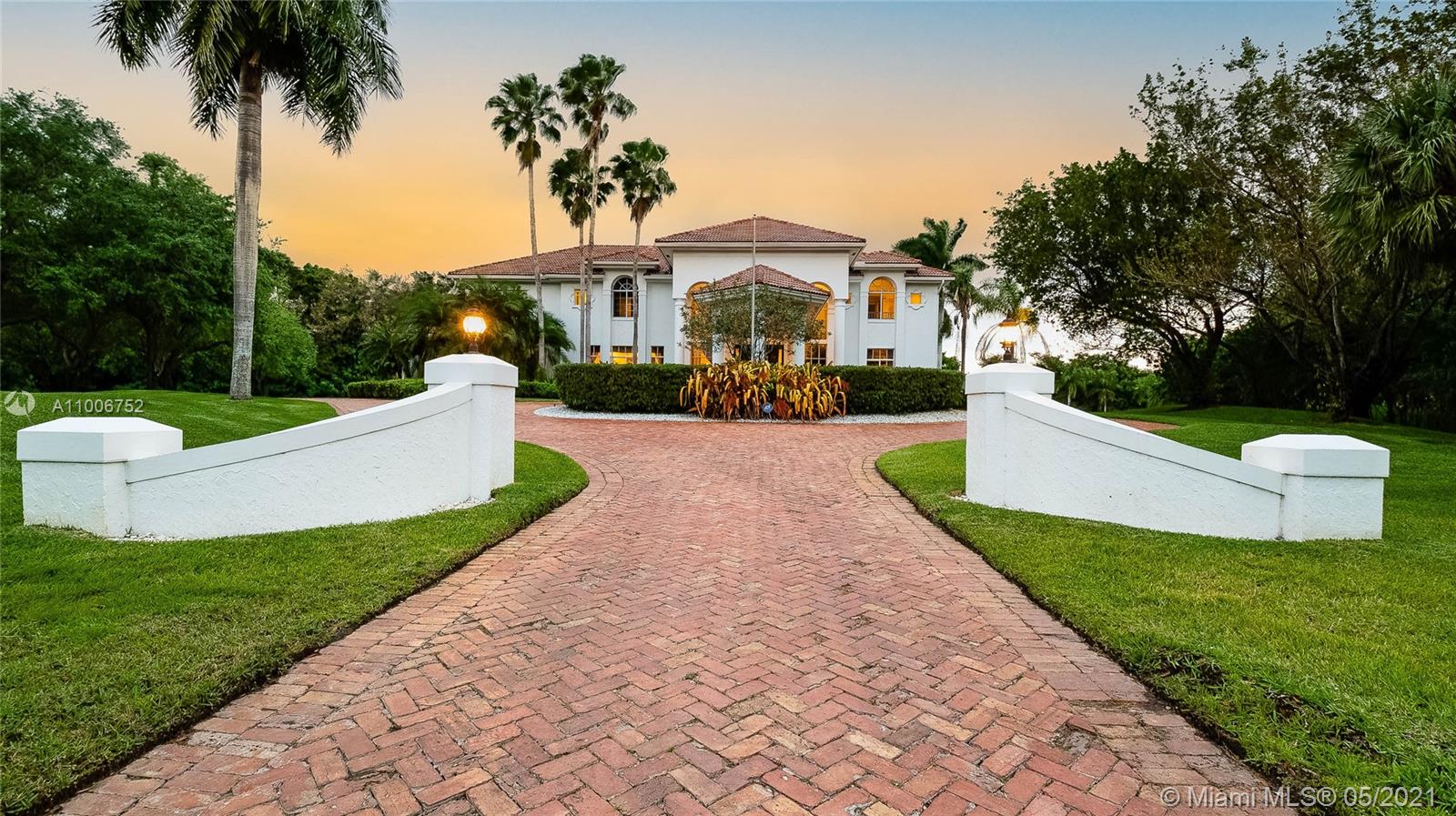 2920 Luckie Road Weston, FL 33331 - Photo 7 of 60 a front view of a house with a garden and trees