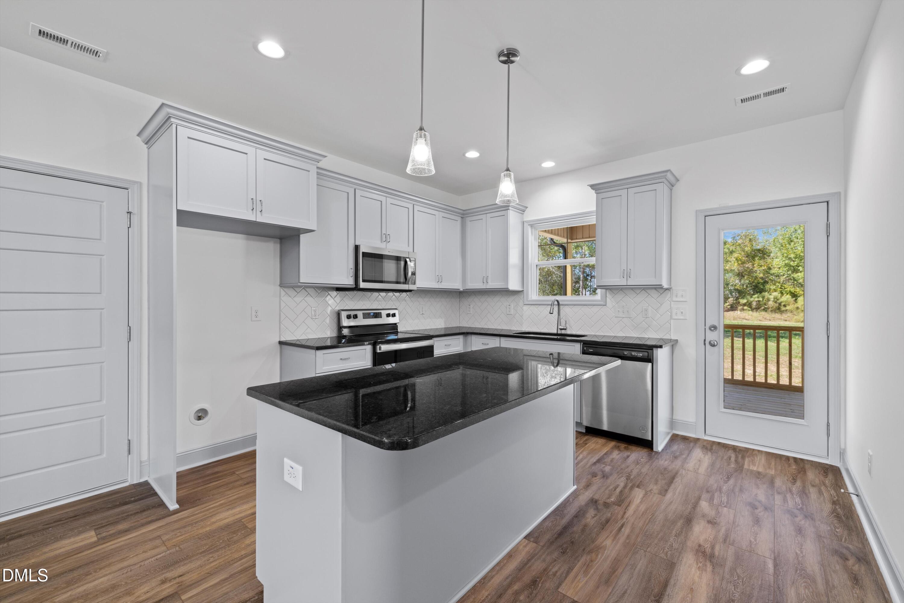 73 Falls Riv Court Broadway, NC 27505 - Photo 1 of 39 a kitchen with granite countertop a sink a counter space appliances and cabinets