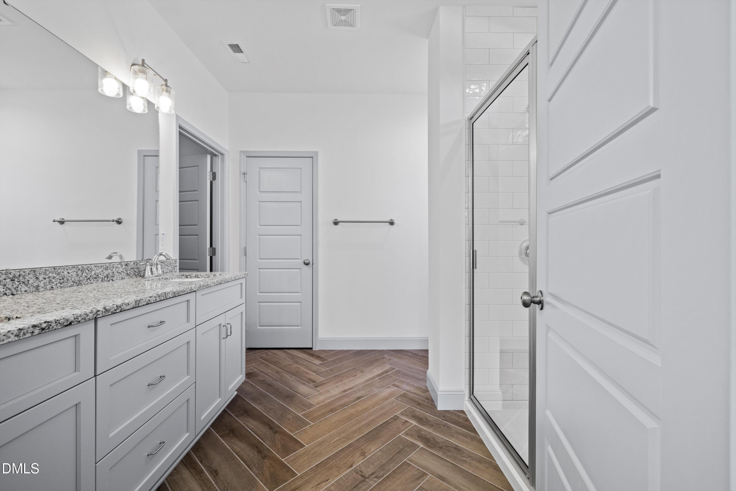 73 Falls Riv Court Broadway, NC 27505 - Photo 16 of 39 a bathroom with a granite countertop sink a mirror and a shower