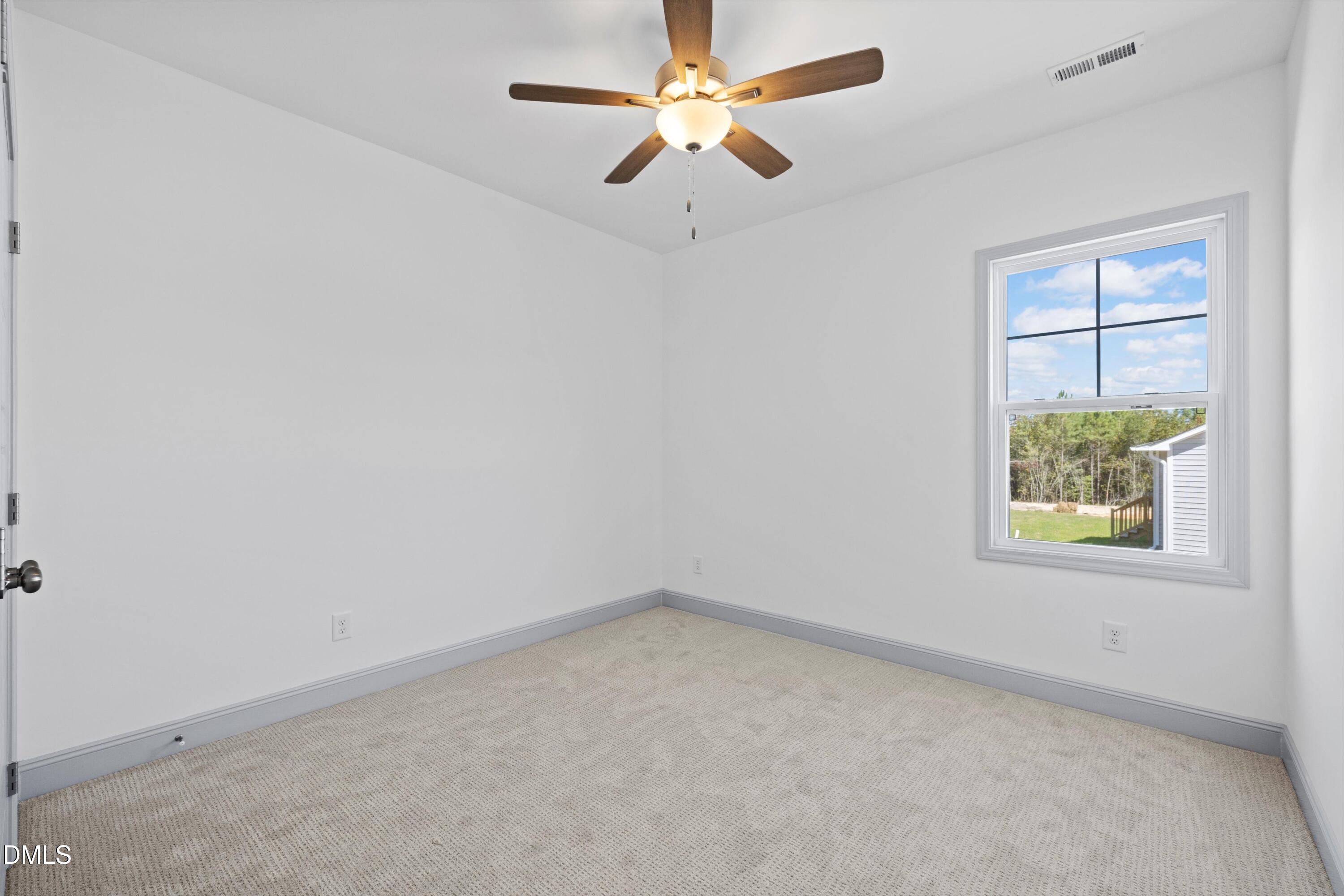 73 Falls Riv Court Broadway, NC 27505 - Photo 29 of 39 an empty room with a window and a fan