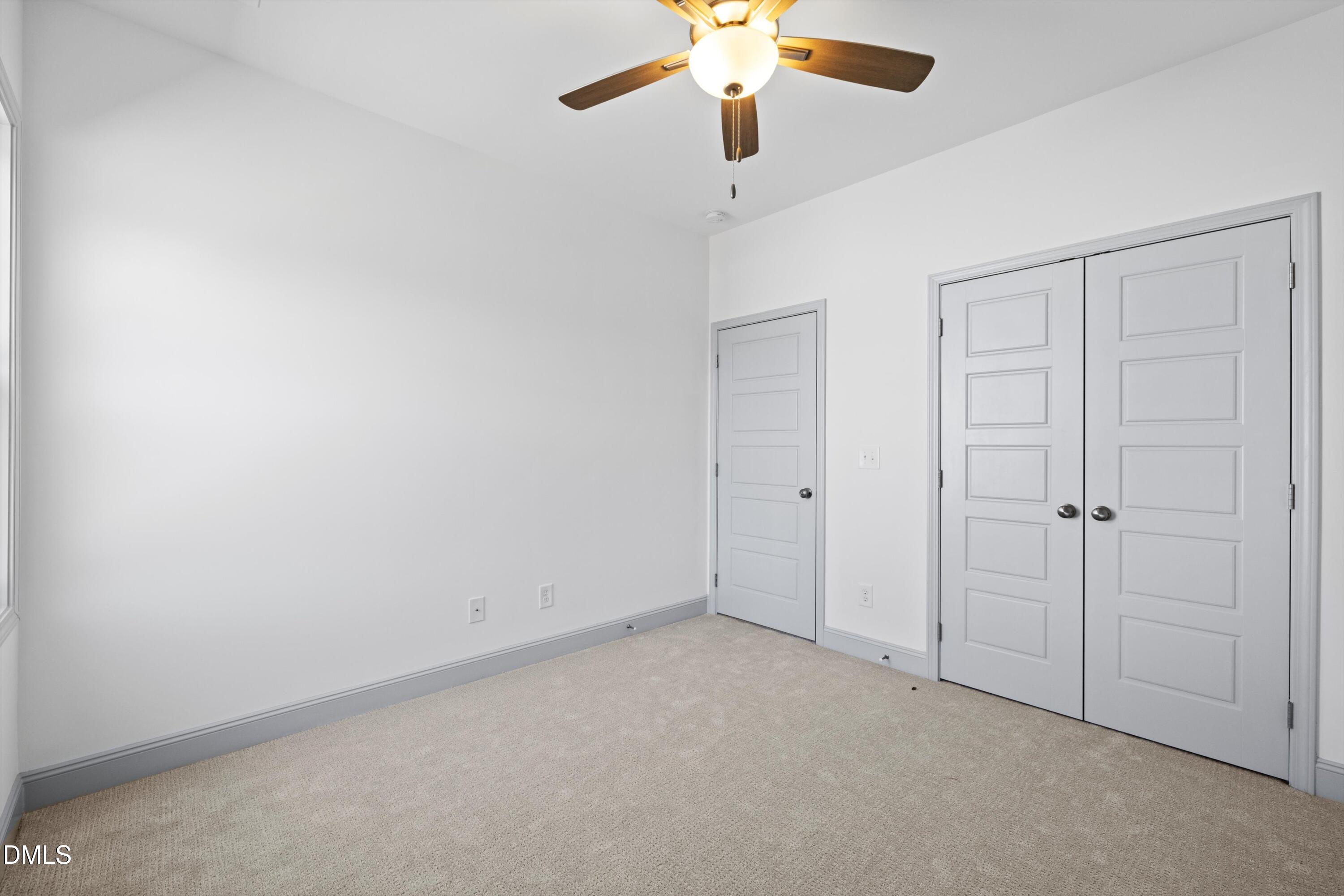73 Falls Riv Court Broadway, NC 27505 - Photo 31 of 39 an empty room with a chandelier fan and closet