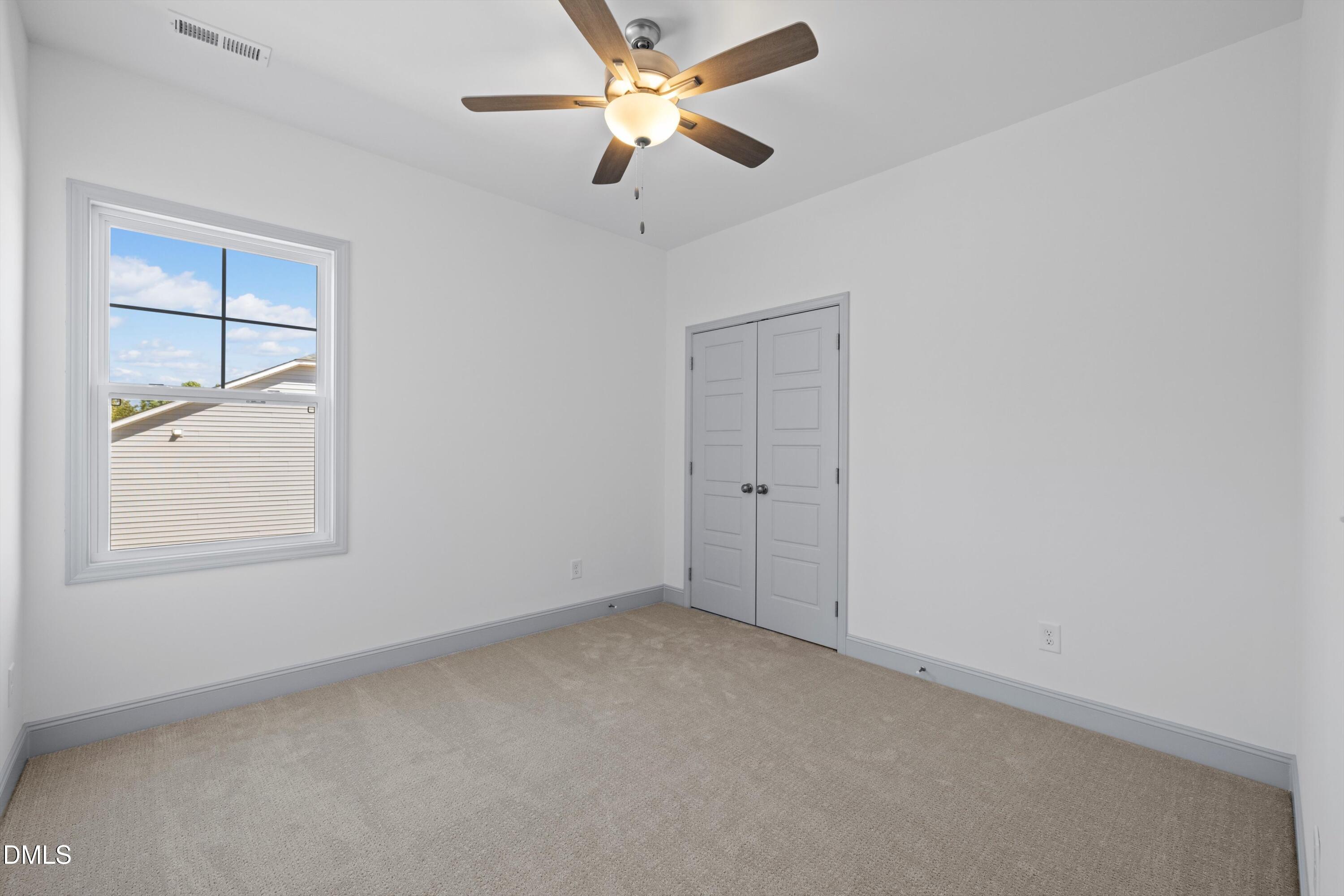 73 Falls Riv Court Broadway, NC 27505 - Photo 32 of 39 an empty room with a window and a fan