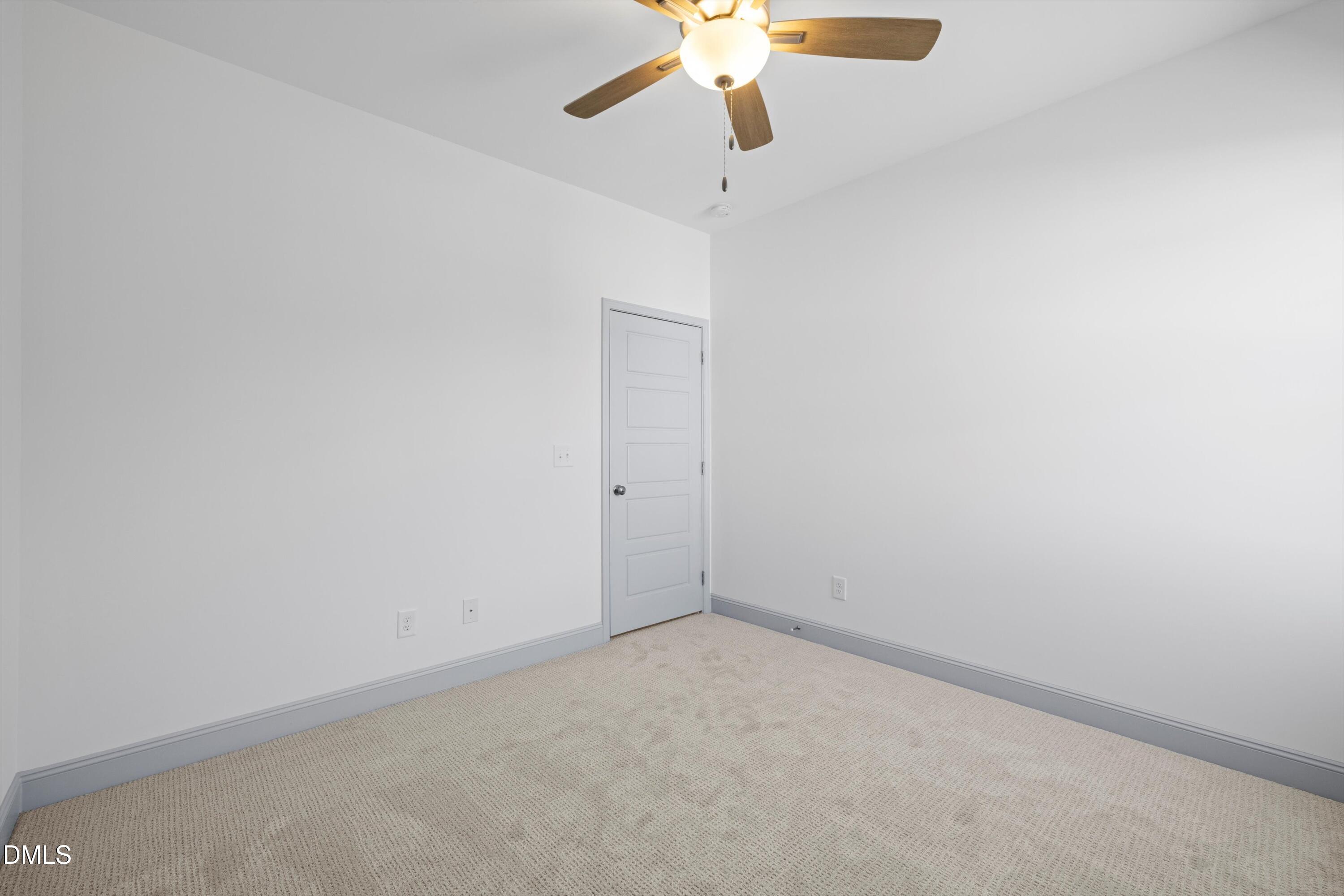 73 Falls Riv Court Broadway, NC 27505 - Photo 34 of 39 an empty room with a ceiling fan and wooden floor