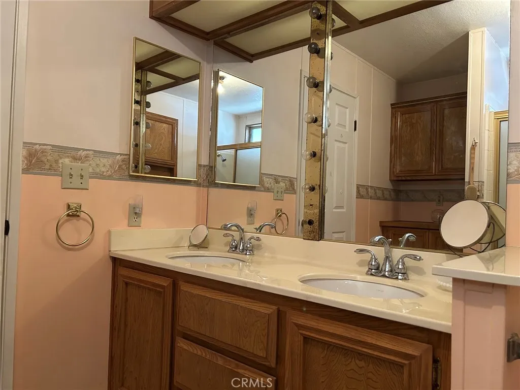 27250 Murrieta Road, Unit 347 Menifee, CA 92586 - Photo 20 of 38 a bathroom with a granite countertop sink a mirror and a shower