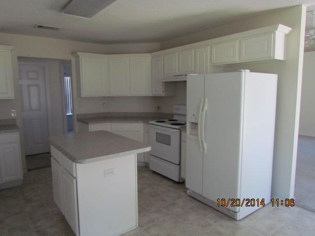 1226 Northview Drive Crestview, FL 32536 - Photo 7 of 13 a kitchen with white cabinets and white appliances