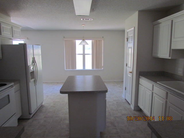 1226 Northview Drive Crestview, FL 32536 - Photo 8 of 13 a kitchen with a refrigerator and a sink