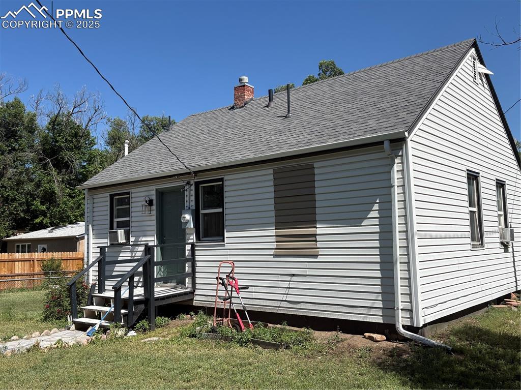 2453 East Willamette Avenue, Unit 1/2 Colorado Springs, CO 80909 - Photo 3 of 16 a front view of a house with garden
