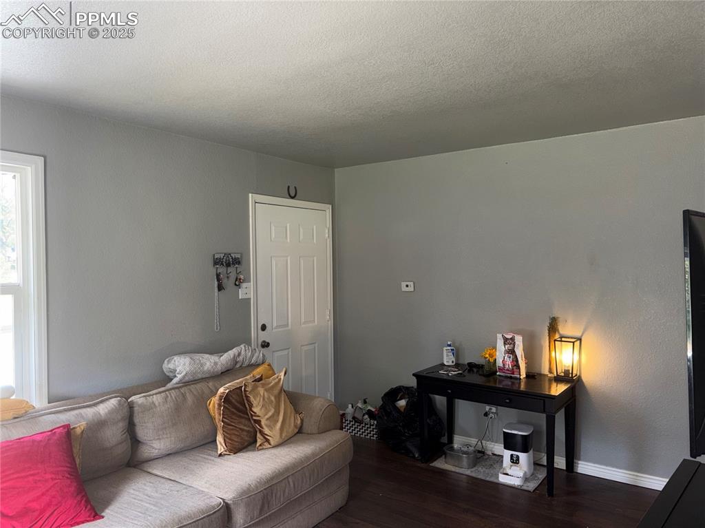 2453 East Willamette Avenue, Unit 1/2 Colorado Springs, CO 80909 - Photo 5 of 16 a living room with furniture and a lamp