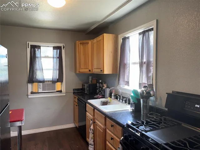 a kitchen with a sink stove top oven and cabinets