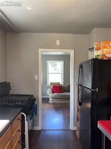 a kitchen with a refrigerator and a stove