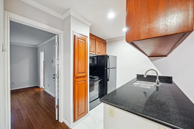 a kitchen with stainless steel appliances granite countertop a refrigerator and a sink