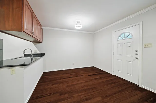 a view of a room with wooden floor