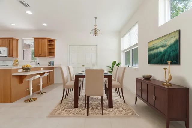 a bedroom with a bed a window and a flat screen television