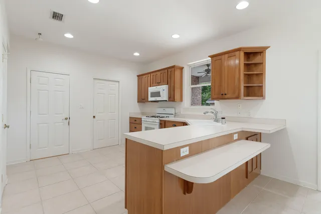 an aerial view of a town with residential houses and lake view