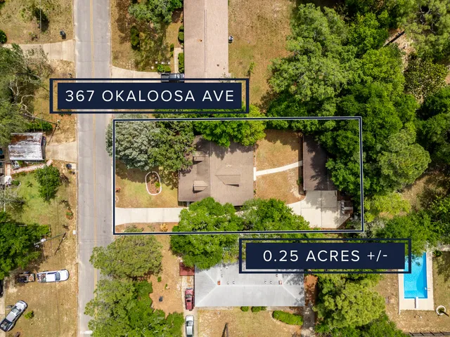 an empty room with windows and chandelier fan