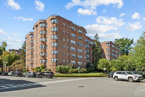 a view of a tall building next to a road