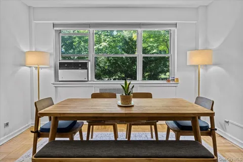 a view of a dining room with furniture and a window