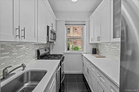 a kitchen that has a sink and a stove