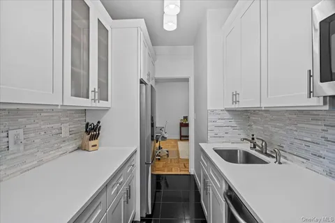 a kitchen with a sink and cabinets