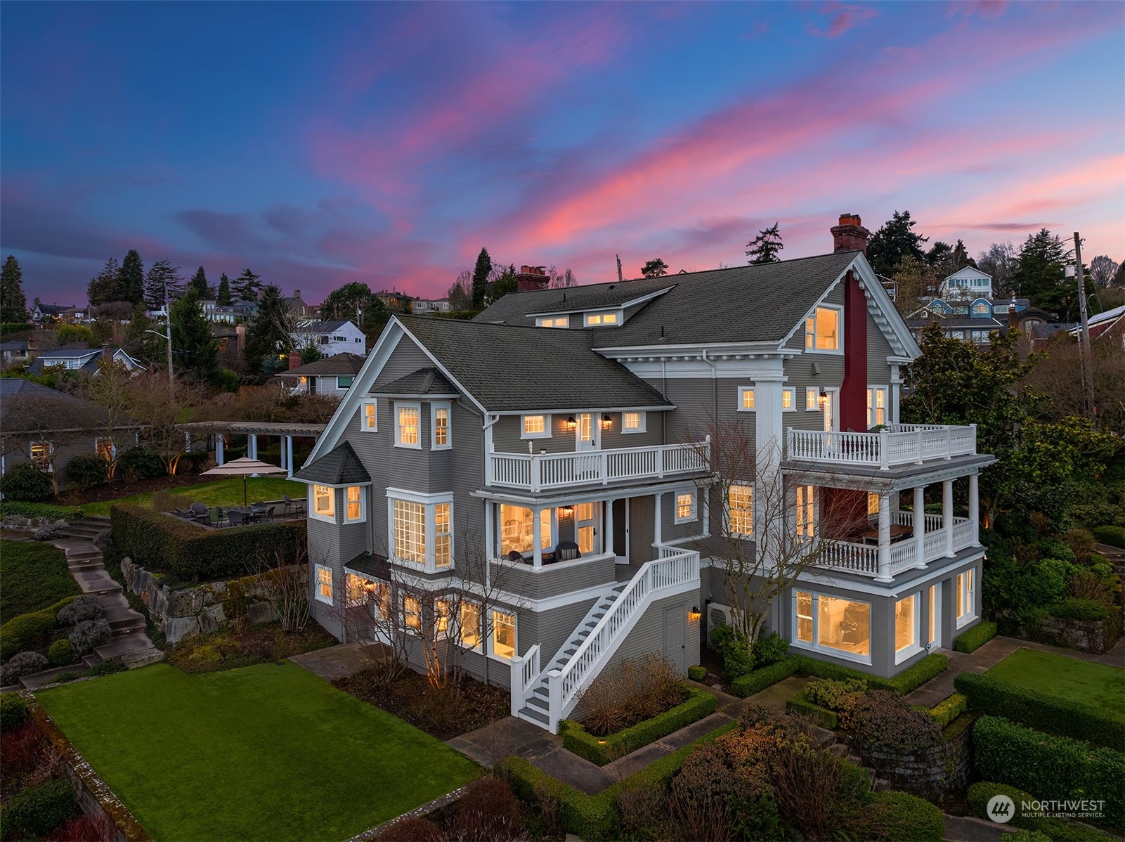 a front view of a house with a yard fire pit and outdoor seating
