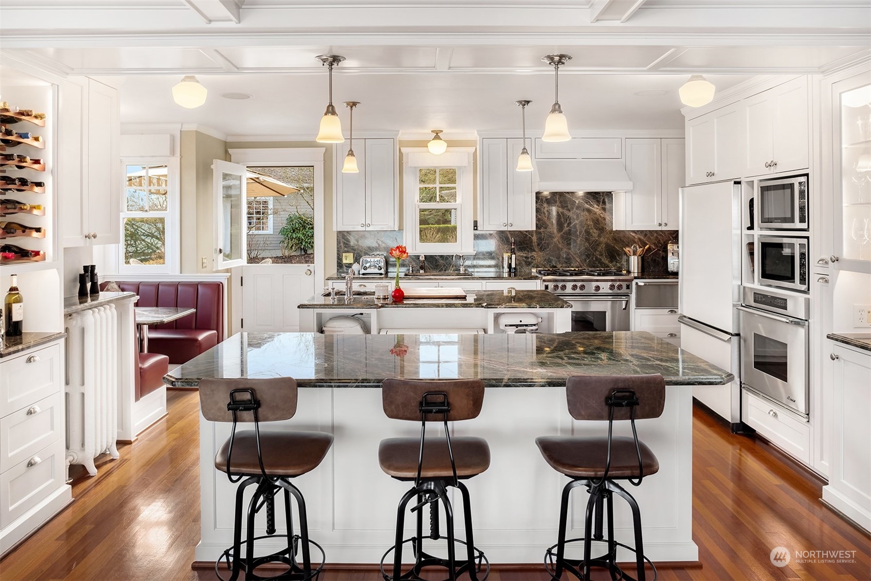 3708 42nd Avenue South Seattle, WA 98144 - Photo 9 of 40 a kitchen with stainless steel appliances kitchen island granite countertop a dining table chairs and granite counter tops