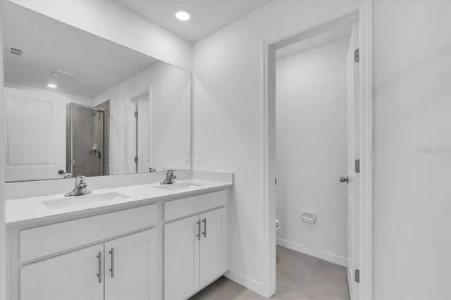 a bathroom with 2 sink tub and a mirror