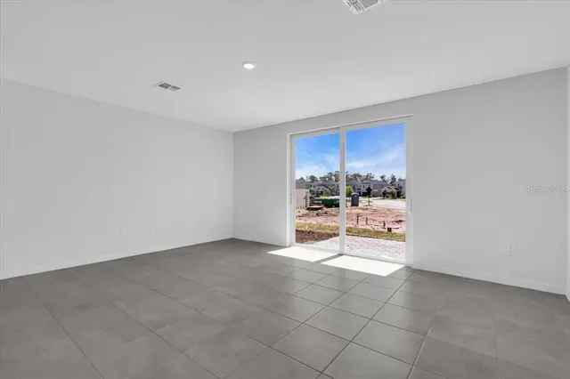 a view of kitchen with refrigerator and window