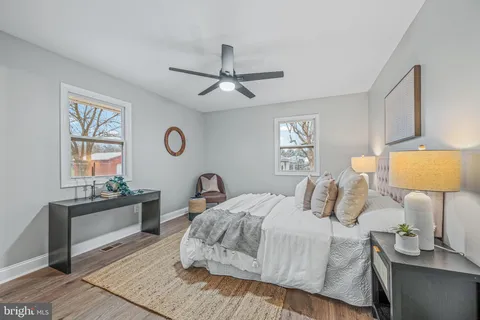 a bedroom with a bed and a lamp on dresser