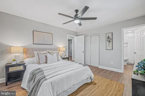 a bedroom with a large bed and a chandelier