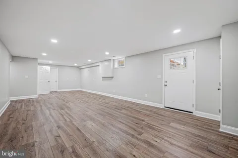 a view of room with wooden floor and fan