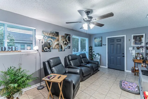 a living room with furniture and wooden floor