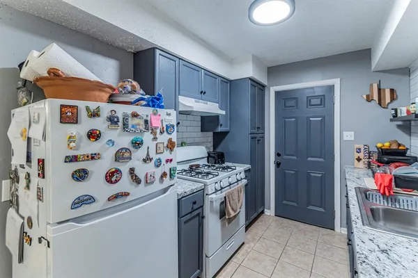 a kitchen with stainless steel appliances a refrigerator and a stove