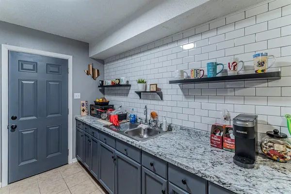 a kitchen with sink and cabinets