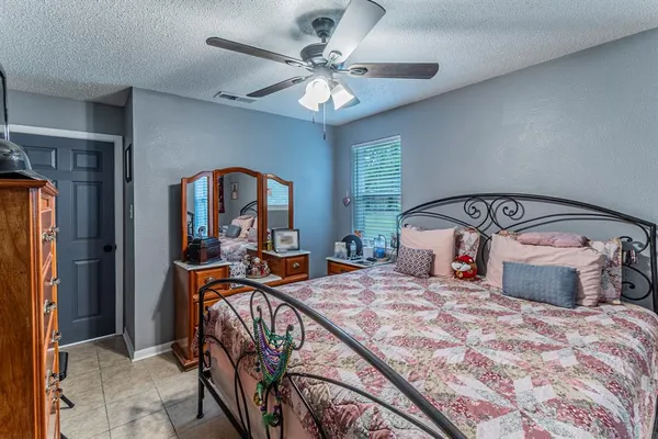 a bedroom with a large bed and a chandelier