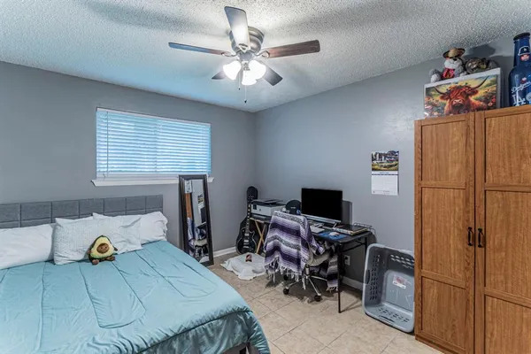 a bedroom with a bed and a desk